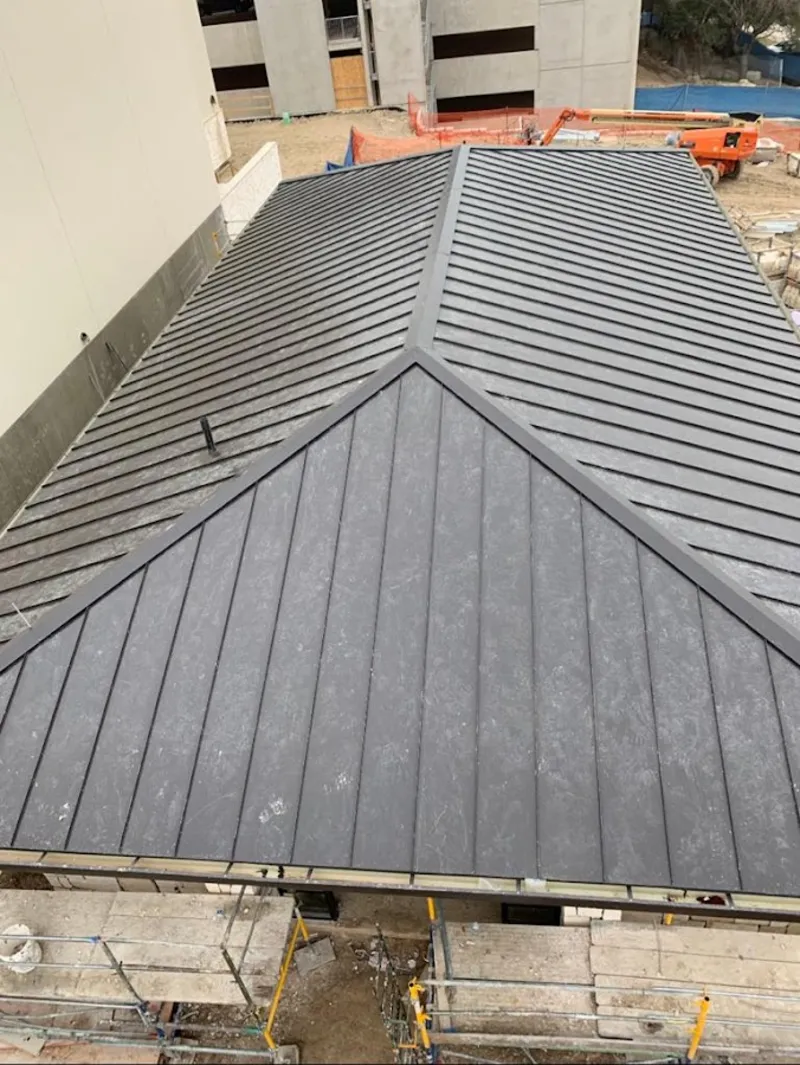 Commercial metal roof construction with crane equipment in Centralia